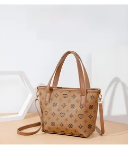 Detail of vintage brown printed bucket bag with metal flower charm and reinforced handles