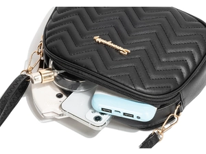 Detail of black wave quilted crossbody bag showing storage of phone and power bank