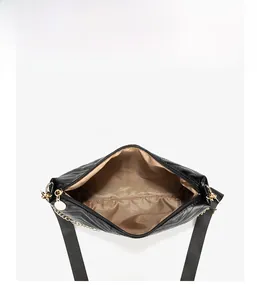 Top view of wave-quilted bucket bag showing spacious interior with brown satin lining