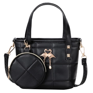 Classic black quilted two-piece bucket bag with golden swan heart charm and round pouch