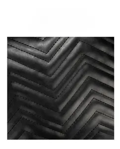 Macro view of chevron quilted black leather detail with fine stitching for bucket bags