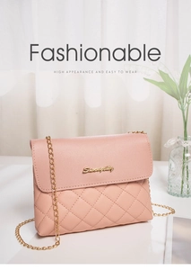Detail of pink quilted shoulder bag with gold chain and metal brand logo plaque