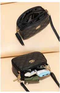 Macro detail of spacious black quilted crossbody bag with multiple interior compartments