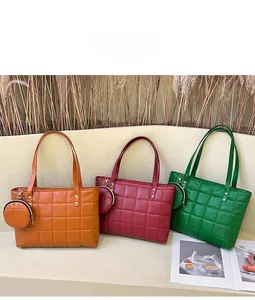 Three quilted checkerboard tote bags in orange, deep red, and green with matching coin purses