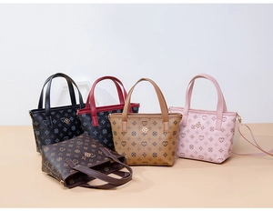 Group shot of mini tote bags in five colors with vintage floral and heart patterns