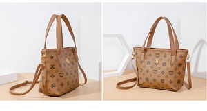 Detail of a brown crossbody mini bag with black floral patterns and gold hardware