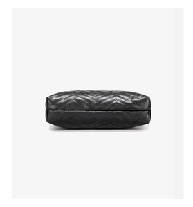 Detailed view of black soft leather crossbody bag featuring classic chevron quilting