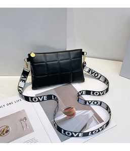 Détail du sac matelassé noir en similicuir avec large bandoulière en tissu LOVE