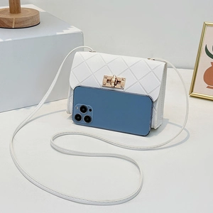 White quilted crossbody bag with gold twist lock and phone inside for size reference