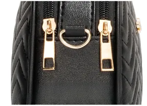 Macro view of wave-patterned bag featuring premium golden double zippers and hardware