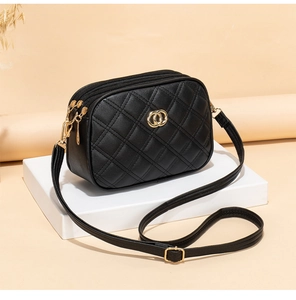 Detail of black quilted leather crossbody bag with golden logo and dual zipper closure
