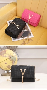 Detailed close-up of woven chain crossbody bags with gold V-logo and tassel decoration