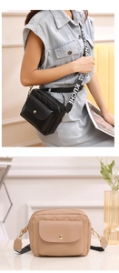 Détail du sac bandoulière matelassé avec fermoir doré et large sangle en tissu imprimé