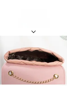 Detailed top view of pink quilted crossbody bag showing interior capacity and gold chain