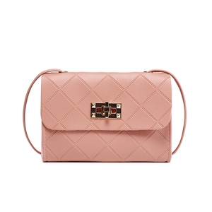 Elegant dusty pink quilted crossbody bag with golden metal turn-lock and slim strap
