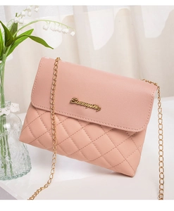 Close-up of pink quilted crossbody bag with golden chain strap and cursive metal logo