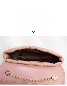 Internal view of pink quilted chain bag showing brown fabric lining and storage capacity