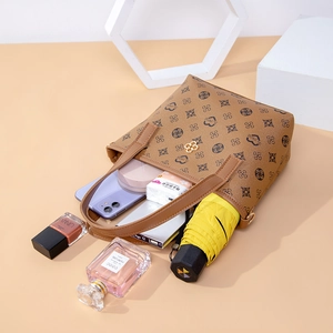 Retro print bucket bag in brown faux leather with heart patterns and gold hardware detail