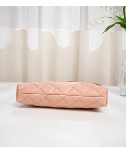Detailed base and side view of pink quilted chain crossbody bag with rhombus stitching