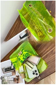 Detail view of fluorescent green transparent PVC bag showing interior storage capacity