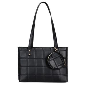 Quilted black tote bag with matching round coin purse and elegant gold-tone hardware