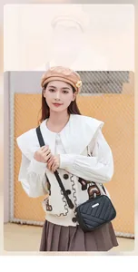 Classic black crossbody bag with V-shaped quilted texture and gold metal buckle hardware