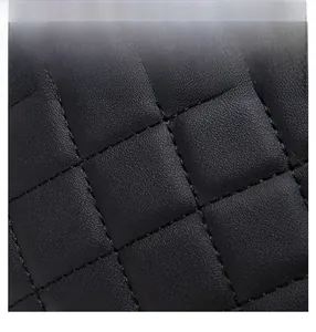 Detail of soft black quilted leather material with scratch-resistant and durable texture