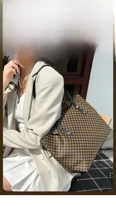 Brown tote bag with circle geometric print and black handles shown in a lifestyle scene