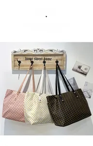 Detailed trio of vintage tote bags with geometric dot patterns on stylish wall hooks