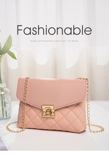 Detailed close-up of pink quilted crossbody bag with gold chain and square metal lock