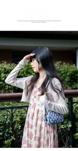 Blue and white checkered denim underarm bag with black strap and golden zipper detail