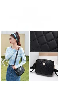 Detail of black quilted crossbody bag with metal bow buckle and stylish tassel charm