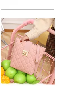 Pink quilted bucket bag detail with golden metal lock and adjustable shoulder strap