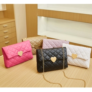 Close-up of quilted heart-shaped chain bags in five different fashion colors
