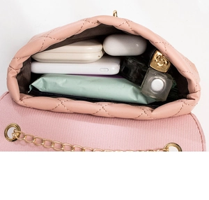 Pink quilted mini bag interior showing capacity for cosmetics and power bank
