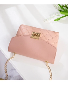 Close-up of light pink quilted mini bag with golden chain and square twist lock