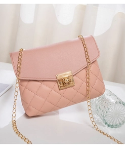 Close-up of pink quilted crossbody bag featuring golden chain strap and twist lock