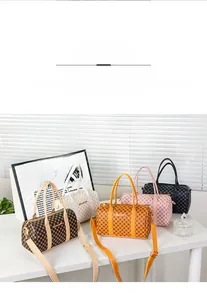Detailed group shot of mini Boston bags in five colors with classic patterns and straps