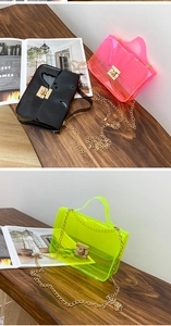 Detailed view of clear PVC jelly crossbody bags with metal chains and turn-lock closures