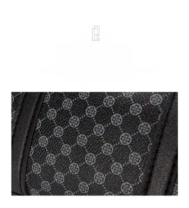 Macro detail of dark brown clover pattern on textured faux leather boston handbag
