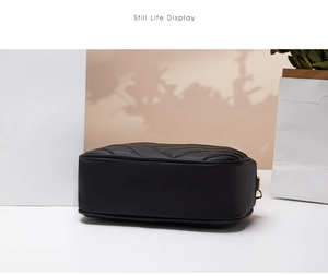 Detailed bottom view of black quilted crossbody bag with luxury V-stitch patterns