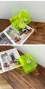 Detail of neon green transparent jelly bag with gold chain strap and metal clasp