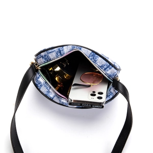 Blue denim floral crossbody bag with leather strap showing spacious inner storage