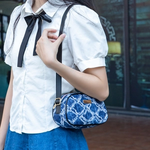 Blue denim pattern small crossbody bag with adjustable strap and vintage texture