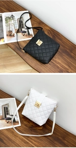 Detail of quilted leather bags in black and white with elegant gold twist-lock closures