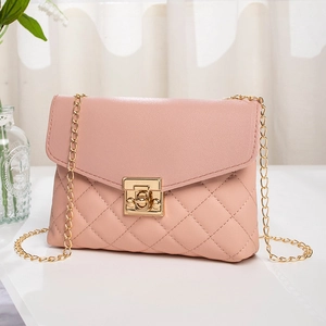 Minimalist nude pink quilted crossbody bag with gold chain strap and turn-lock closure