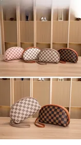 Detail of four semi-circular checkered pouches with leather handles and metal zippers