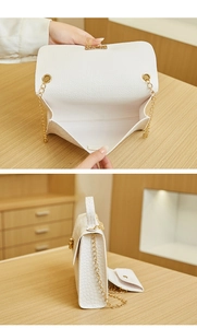 Detail of white crocodile pattern chain bag with a matching mini coin purse set