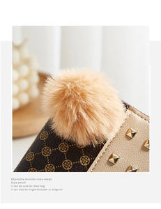 Detail of a brown clover monogram wallet with rivet accents and a soft faux fur pom-pom charm