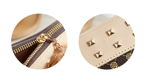 Detailed macro view of the gold zipper, plush charm, and rivet studs on the wallet
